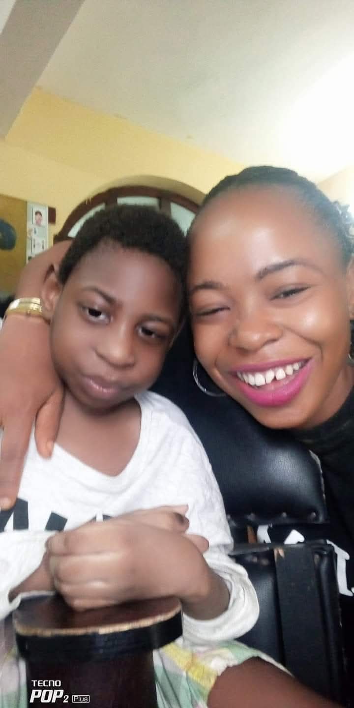 Chidimma, and her son, sitting in their sitting room. The mother smiling to the camera.
